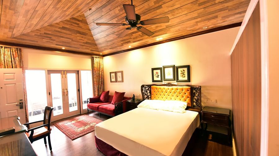 light falling on the bed, which is entering through the glass of the attached balcony - Mayfair Himalayan Spa Resort Kalimpong