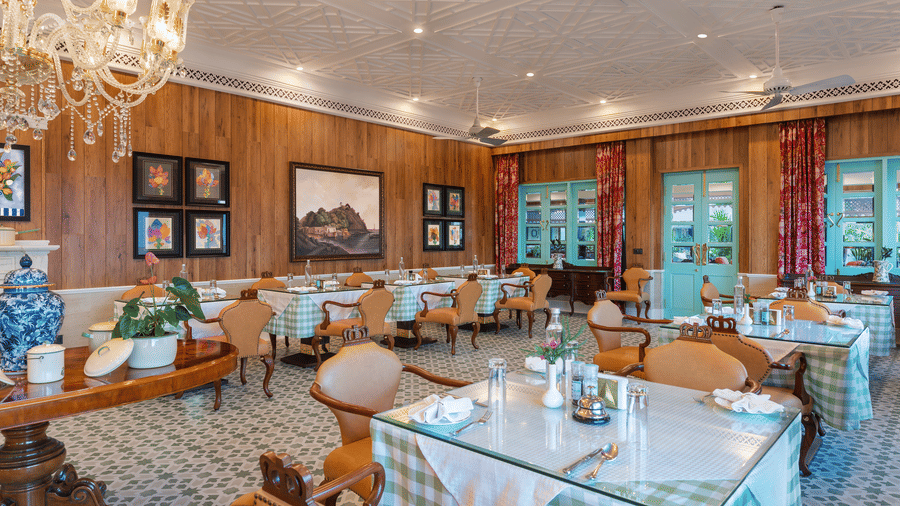 Charming dining area with chandeliers and patterned tiles at Mayfair Manor, Jungpana.