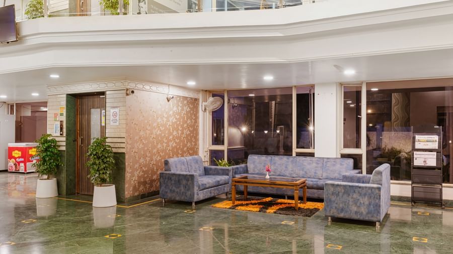 Mayur Retreat lobby area featuring sofas, a coffee table with modern interiors.