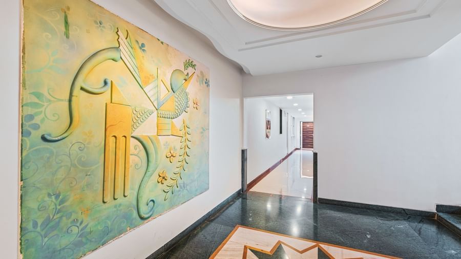 Mayur Retreat's corridor view with a contemporary mural art placed on a wall.