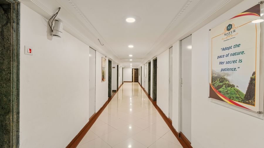 Long view of corridor at Mayur Retreat with white walls and minimal interiors.