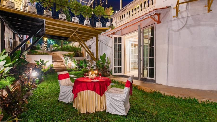 Lawn area arranged for an event showcasing a 2 seater table under a night sky.