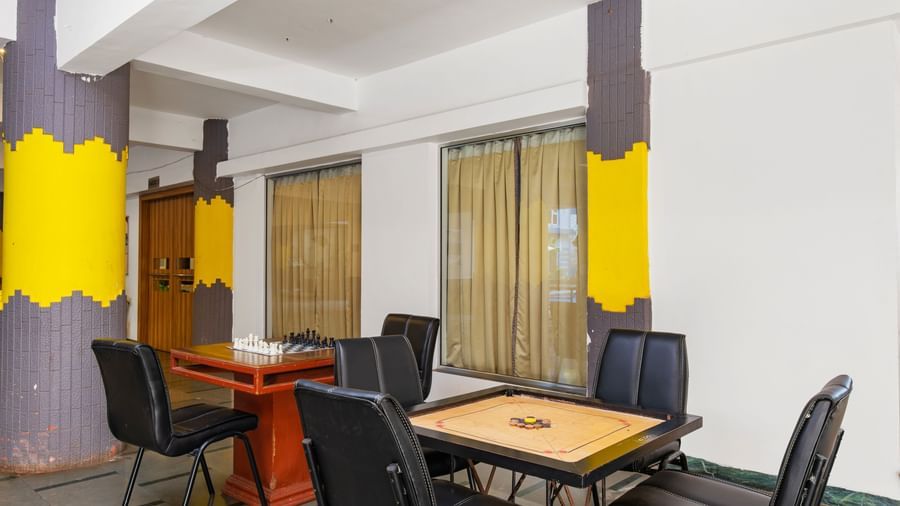 Indoor game area with a carrom board, and other indoor games placed one a table at Mayur Retreat.
