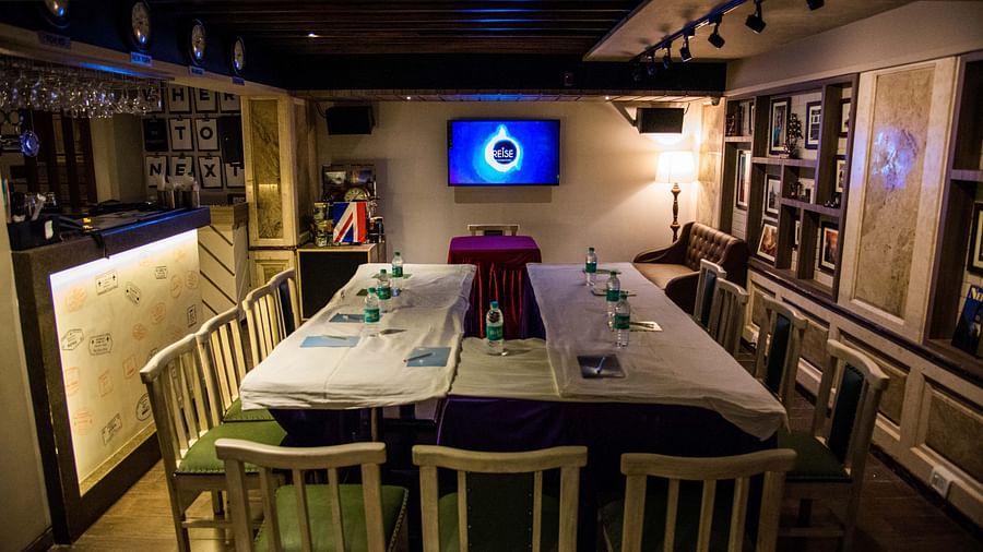 Cosy restaurant interior with a central table set for a meal under warm lighting at Oriental Aster, Mumbai.