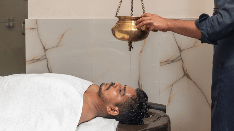 Shirodhara Ayurvedic therapy in progress at DLS Hotels On The Ganges.