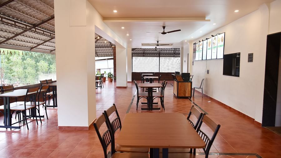 A view of the dining area at Riverside Inn, featuring neatly arranged tables and chairs with ample space around each pair.