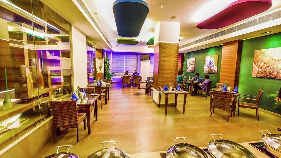 Image of Galleria with seating area and buffet table in front at Swosti Grand, Bhubaneswar