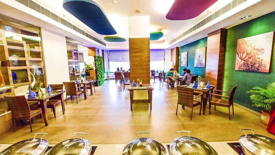 Image of Galleria with seating area and buffet table in front at Swosti Grand, Bhubaneswar