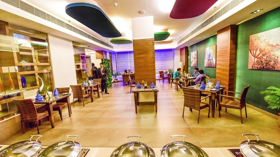 Image of Galleria with seating area and buffet table in front at Swosti Grand, Bhubaneswar