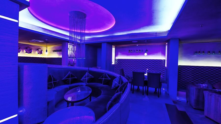 Image of Oceana bar with dim lighting and seating area at Swosti Grand, Bhubaneswar
