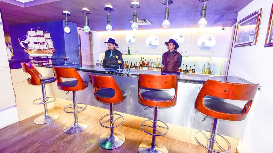 Image of Oceana bar with high chairs in front of the counter table and two people standing behind the counter