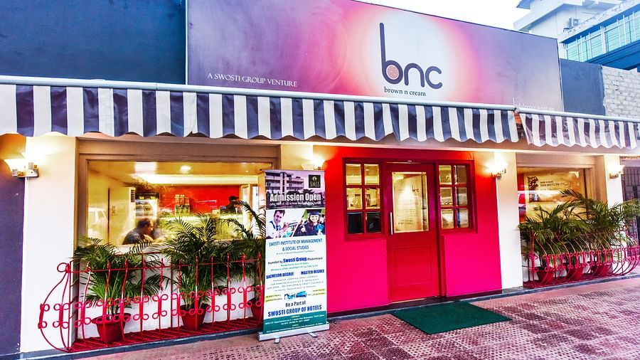 Facade of Brown N Cream with the signboard above the entrance at Swosti Grand, Bhubaneswar