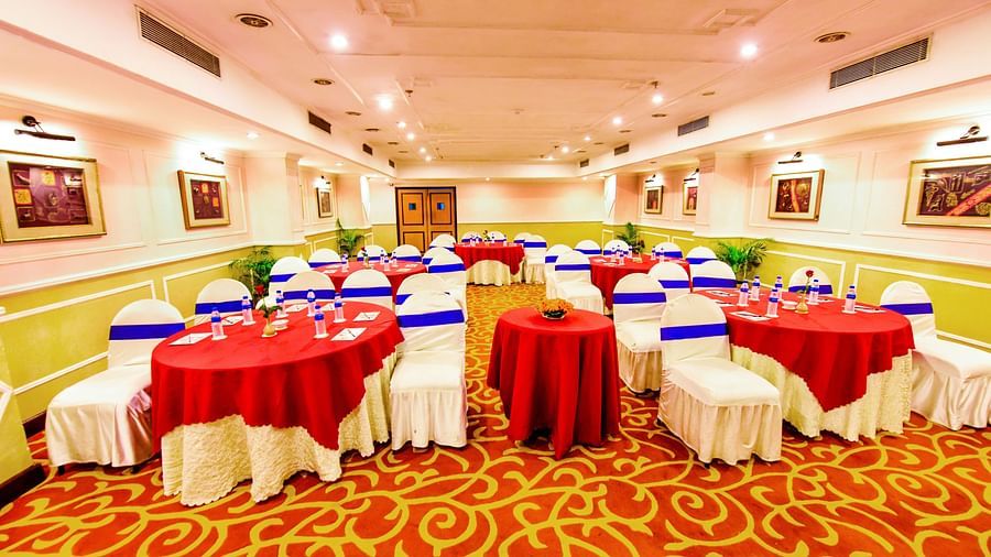 Banquet hall brightly lit and adorned with decorations throughout, perfectly set up for celebrations.