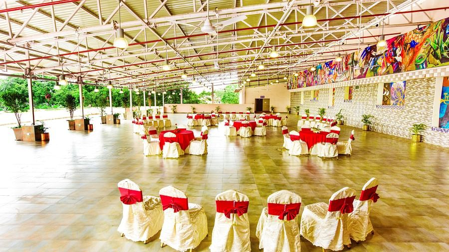 The banquet hall, brightly illuminated and beautifully decorated, is prepared for a memorable celebration.