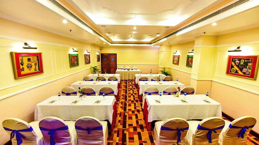 Banquet hall brightly lit and adorned with decorations throughout, perfectly set up for celebrations.