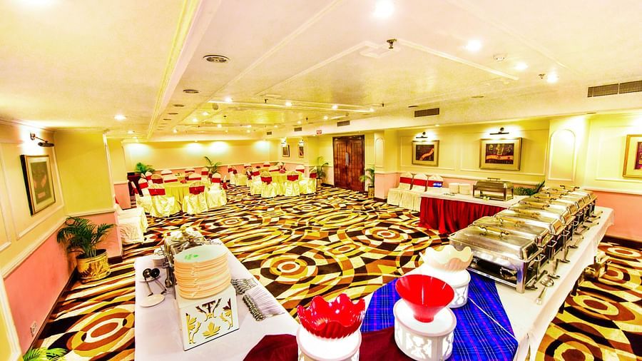 Celebration-ready banquet hall, featuring bright lighting and detailed decorations across the entire space.