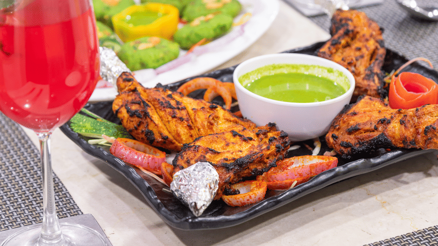 A modern dining setup with cushioned chairs, wooden interiors, and large windows showcasing stunning views at The Solitaire Resort.