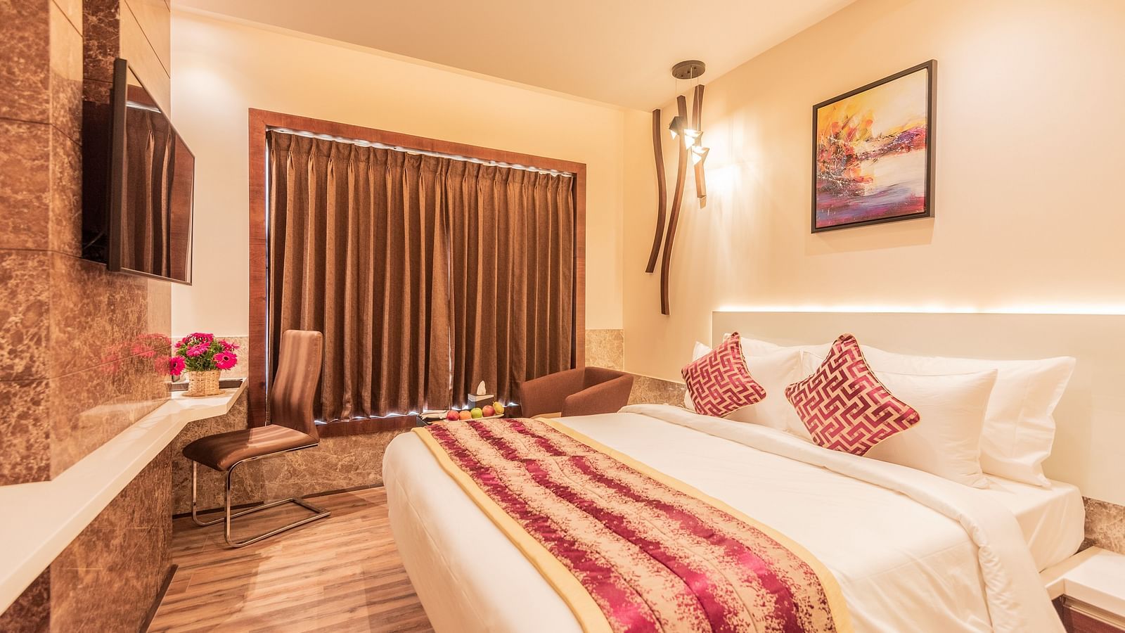 a comfy bed at Club Room featuring a red and yellow blanket and pillow at Hotel Park Elanza, Coimbatore 2