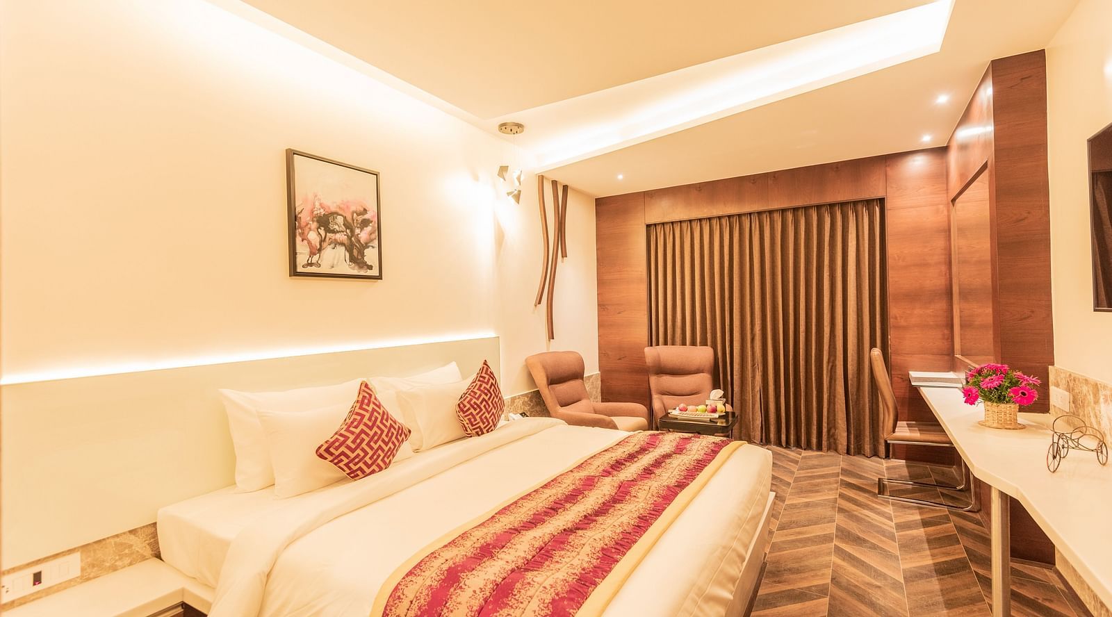 a comfy bed at Club Room featuring a red and yellow blanket and pillow at Hotel Park Elanza, Coimbatore