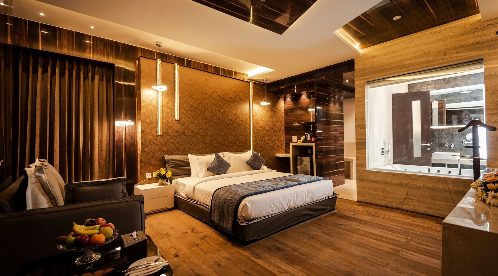 Junior Suite at Hotel Park Elanza, Coimbatore featuring a plush bed and glass-enclosed washroom