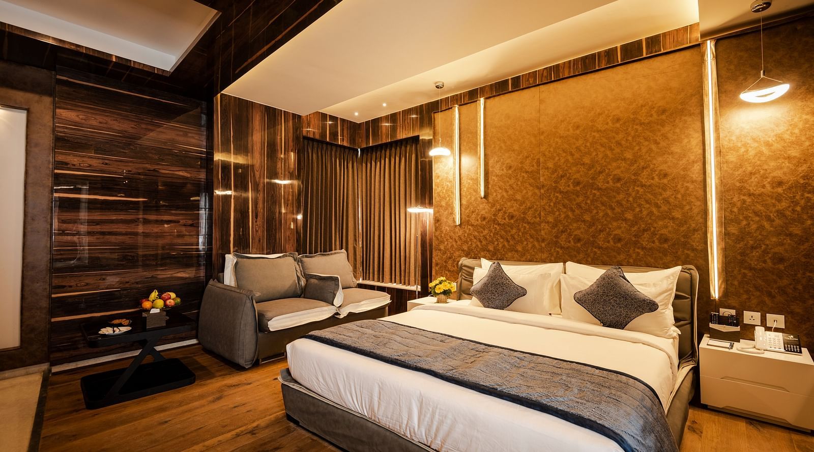 a view of Junior Suite featuring a bed and sofa placed by its side at Hotel Park Elanza, Coimbatore