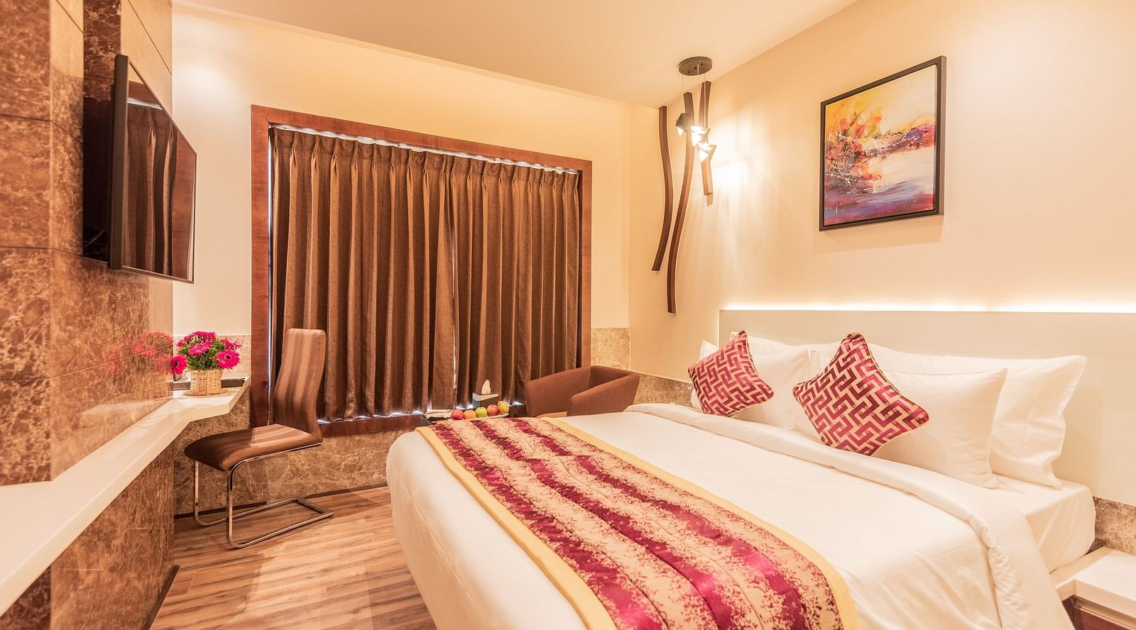 a comfy bed at Club Room featuring a red and yellow blanket and pillow at Hotel Park Elanza, Coimbatore 2