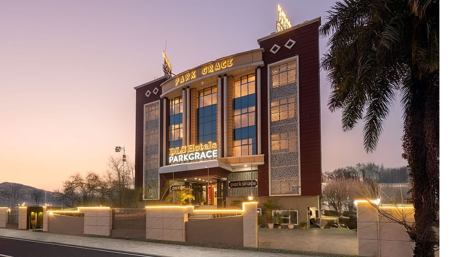 Facade of DLS Park Grace Hotel in Haridwar illuminated with warm yellow lights.