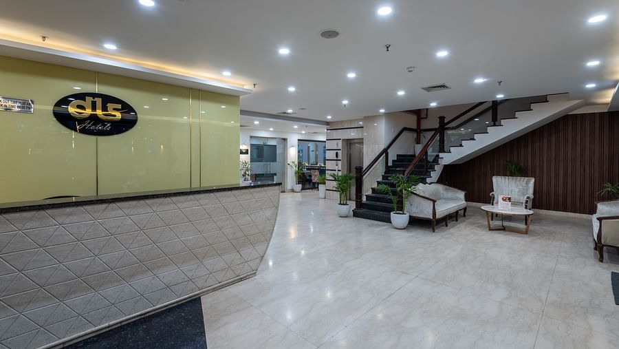 Side view of the reception area with a staircase leading upward at DLS The Classio