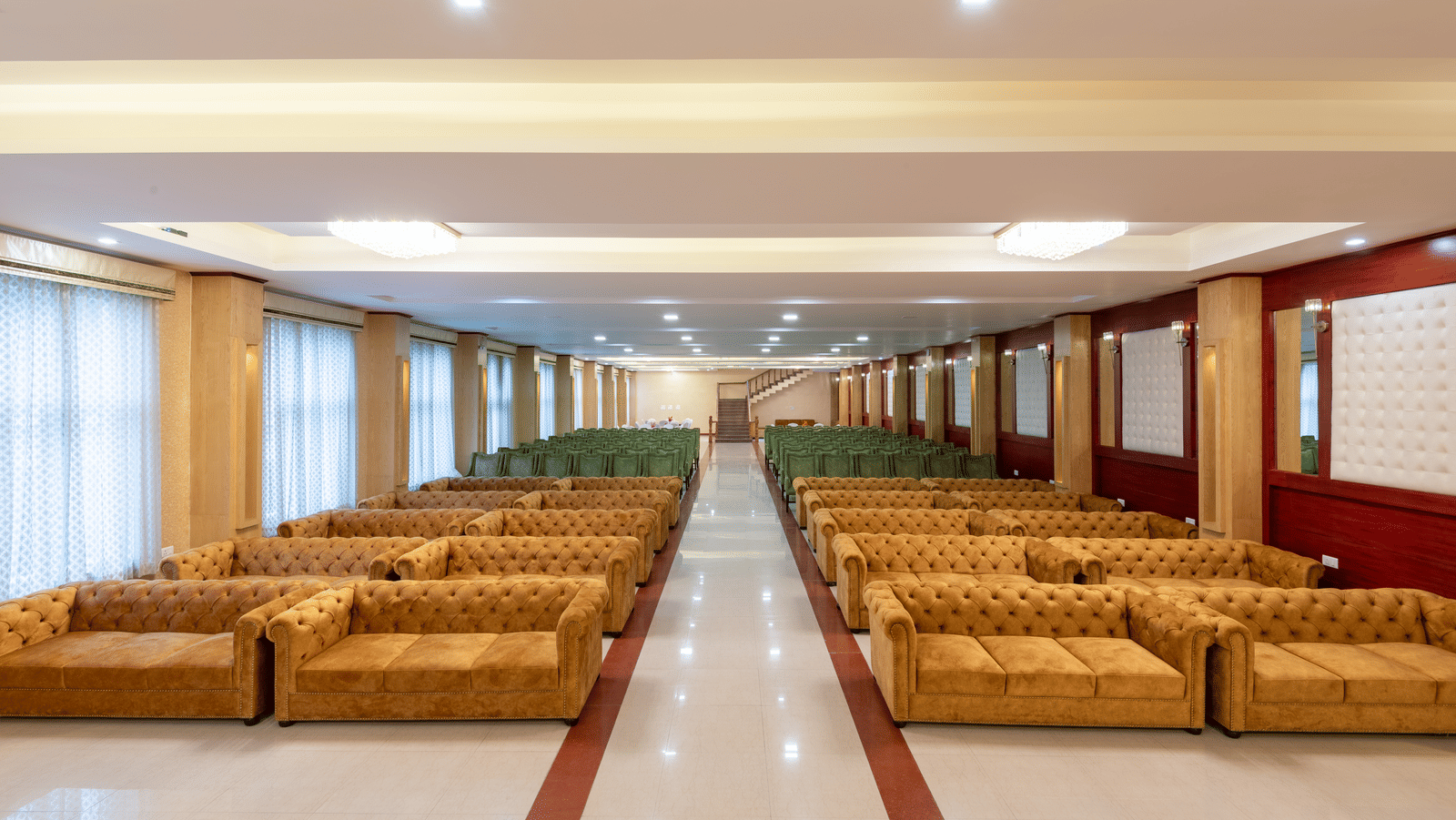 A large DLS Hotels banquet hall featuring a central aisle with symmetrical seating on each side for guests.