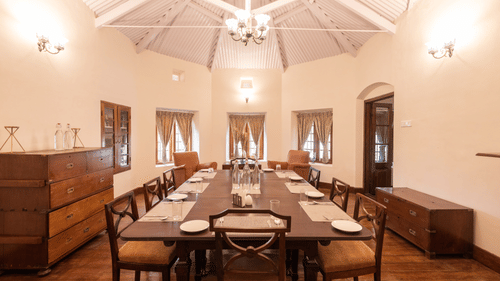 The interiors of the dining hall with a long dining table and rounded walls - Ibex Resort, Coonoor (Leewood).