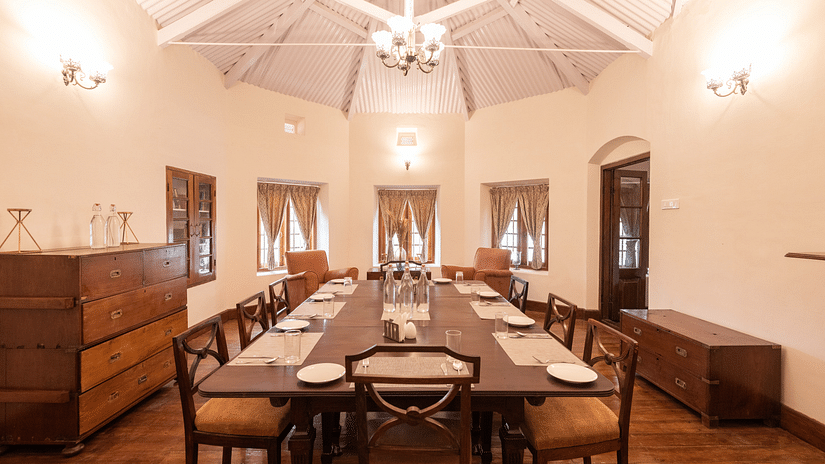 The interiors of the dining hall with a long dining table and rounded walls - Ibex Stays & Trails, Coonoor (Leewood).