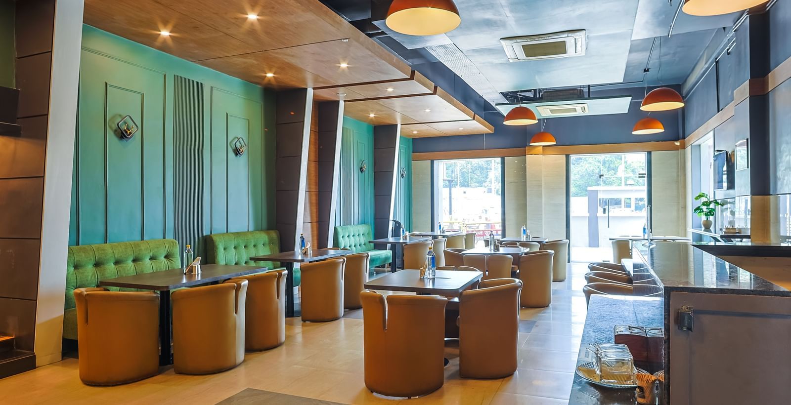 Restaurant dining area with tables, chairs and open layout at Max Hotel Prayagraj.