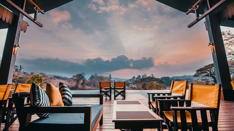 Multi-colured chairs overlooking a vibrant sky - Symphony Samudra Beachside Jungle Resort And Spa, Port Blair