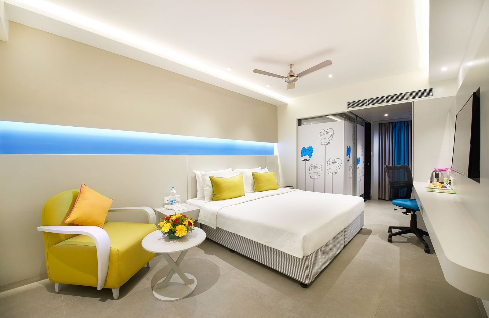 side view of a bedroom with a wall painting at  Zibe Salem by GRT Hotels
