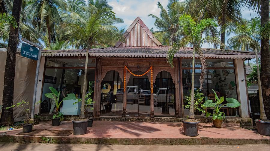 Main entrance with traditional Goan-style architecture surrounded by palm trees at De Soul Santé, Morjim