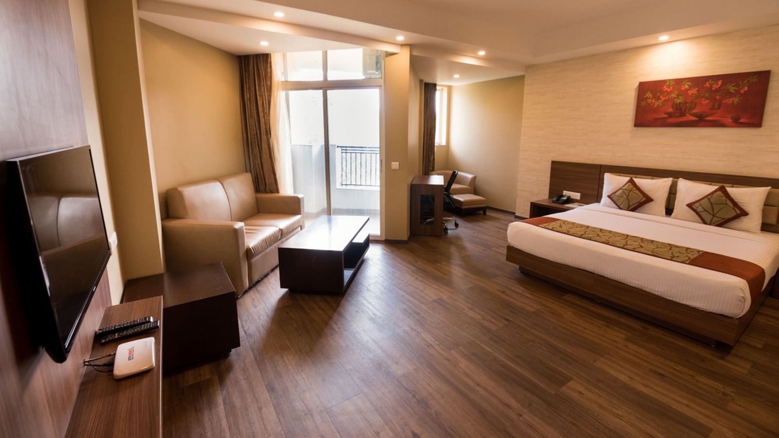 Super Deluxe Rooms with Complimentary Wi-Fi captured with a cosy bed and white linens along with a beige couch - Le ROI Digha Hotel West Bengal7