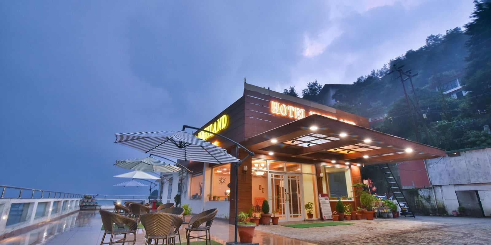 View of DLS Highland Resort and Spa, Mussoorie with comfortable seating area at the front. 