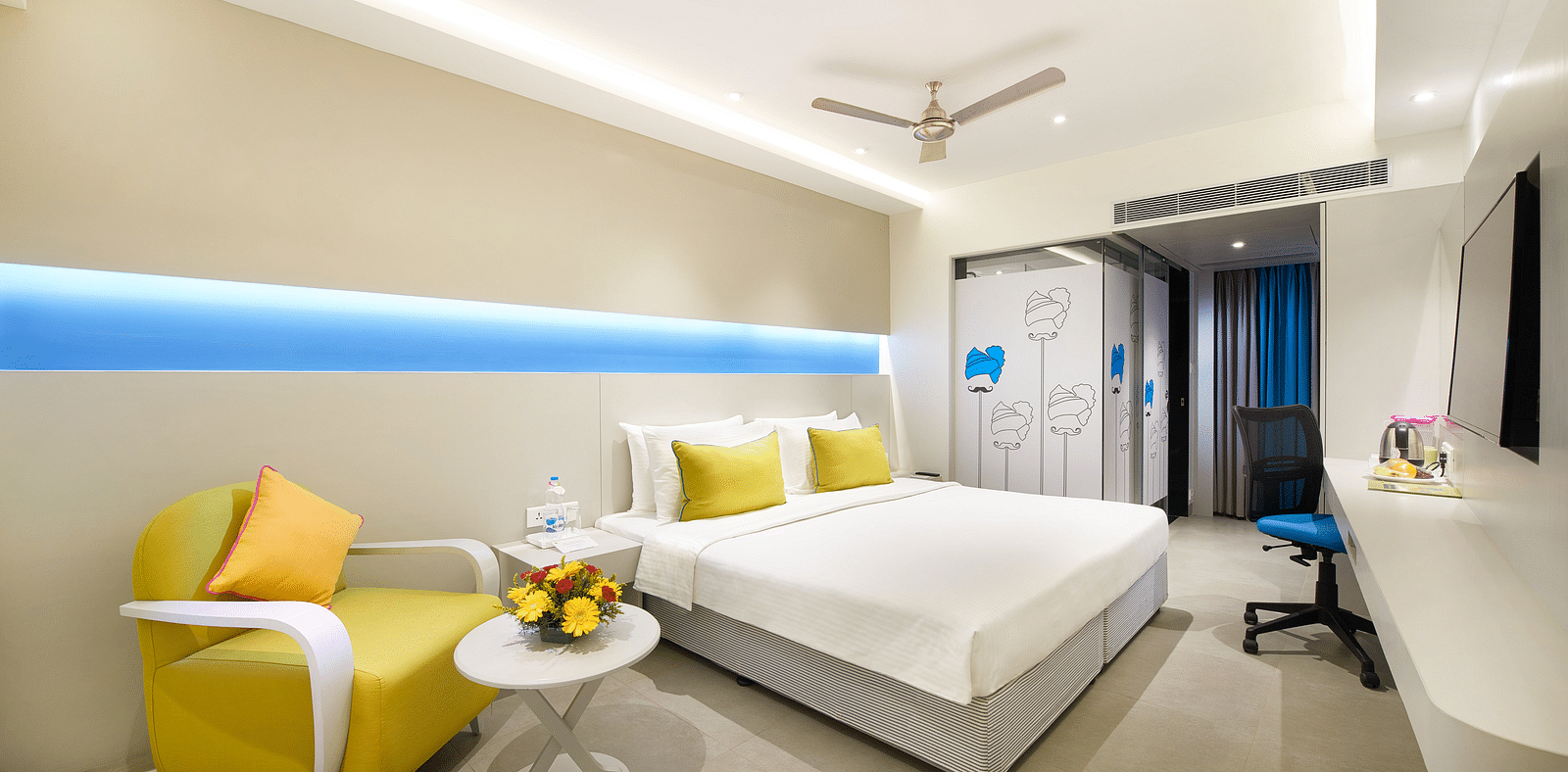 side view of a bedroom with a wall painting at  Zibe Salem by GRT Hotels
