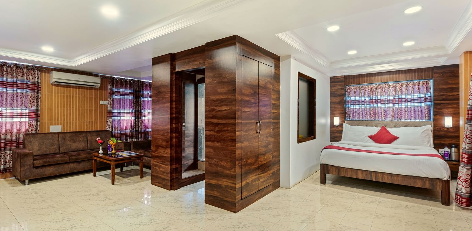 Spacious suite at Mayur Retreat with a seating area, bright lighting, and contemporary decor.