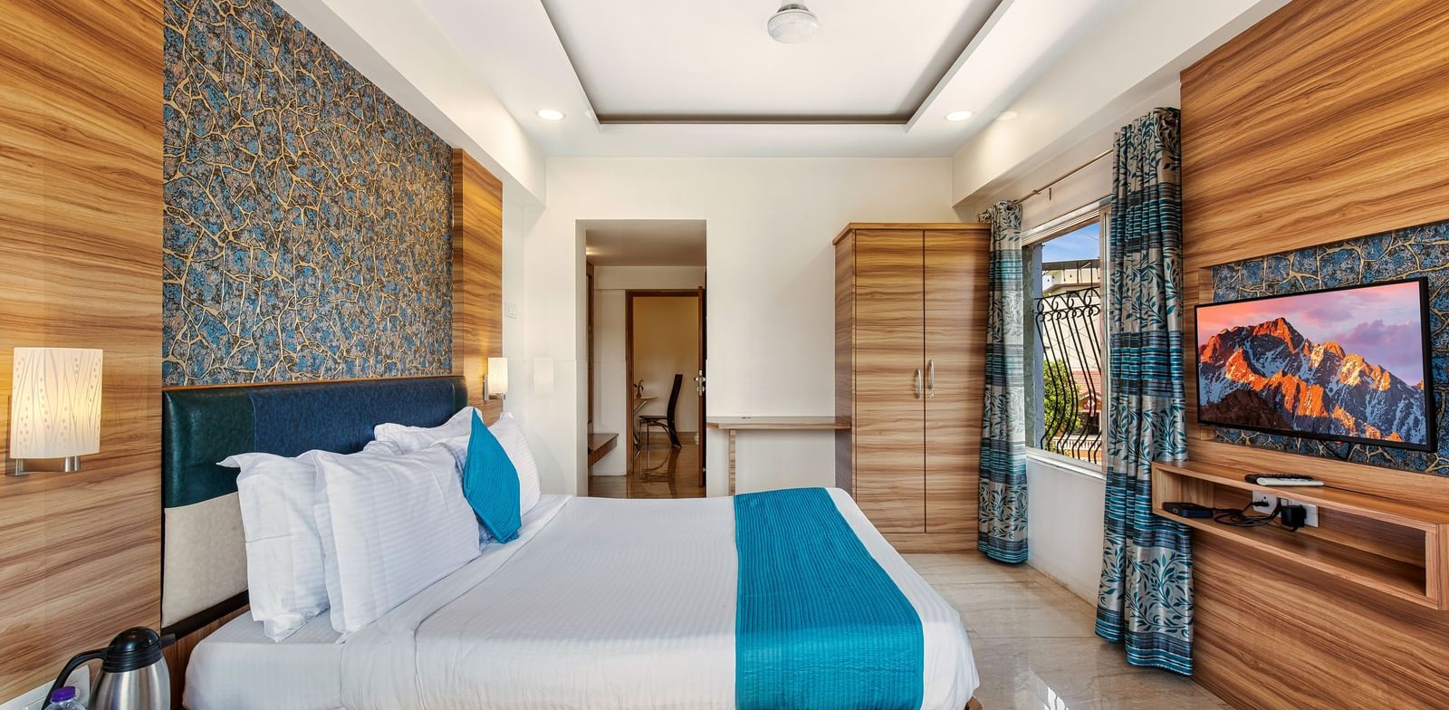 Stylish room at Mayur Retreat with elegant furnishings, blue-themed decor, and a serene ambiance.