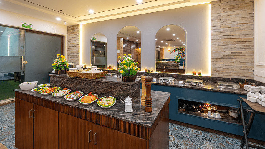 Restaurant with a fresh salad bar and buffet setup in the background at DLS The Classio