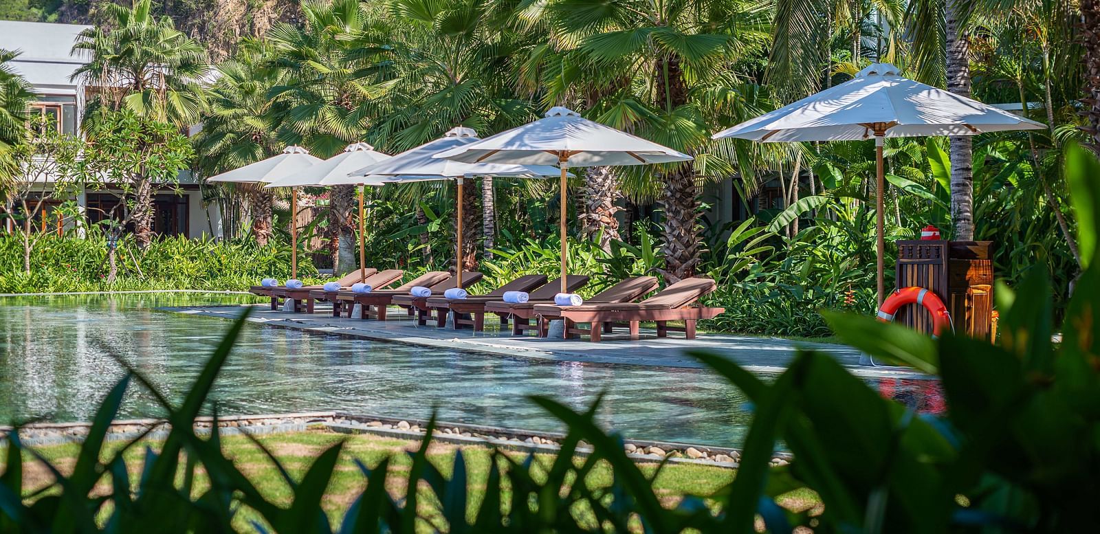 A pool at our resort with parasol by the pool - Alibu Resort Nha Trang
