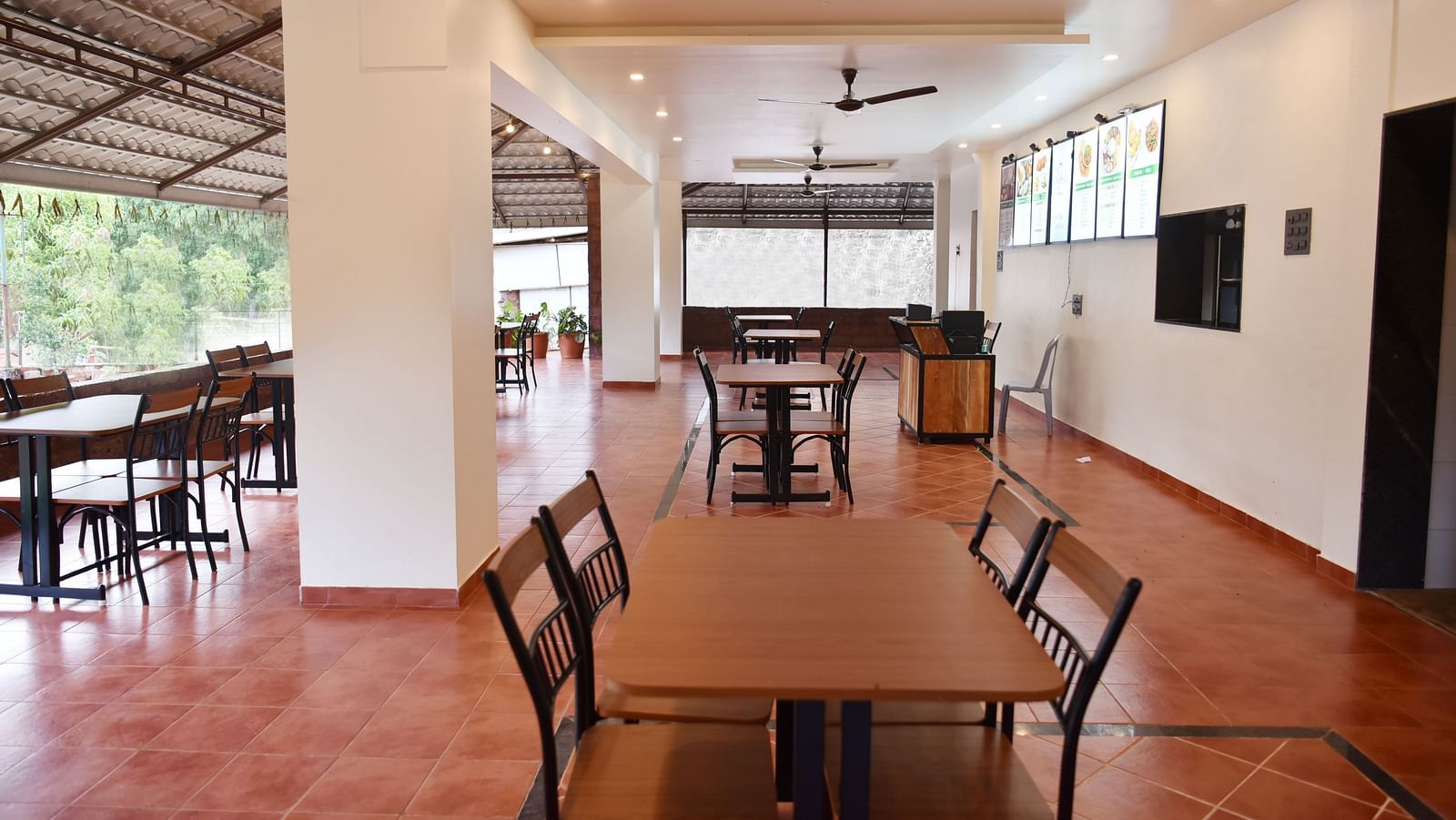 A view of the dining area at Riverside Inn, featuring neatly arranged tables and chairs with ample space around each pair.
