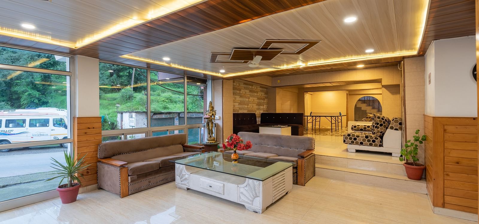 Shot of the lobby at the resort featuring couches and a reception desk | DLS Anupam Resort, Dharamshala