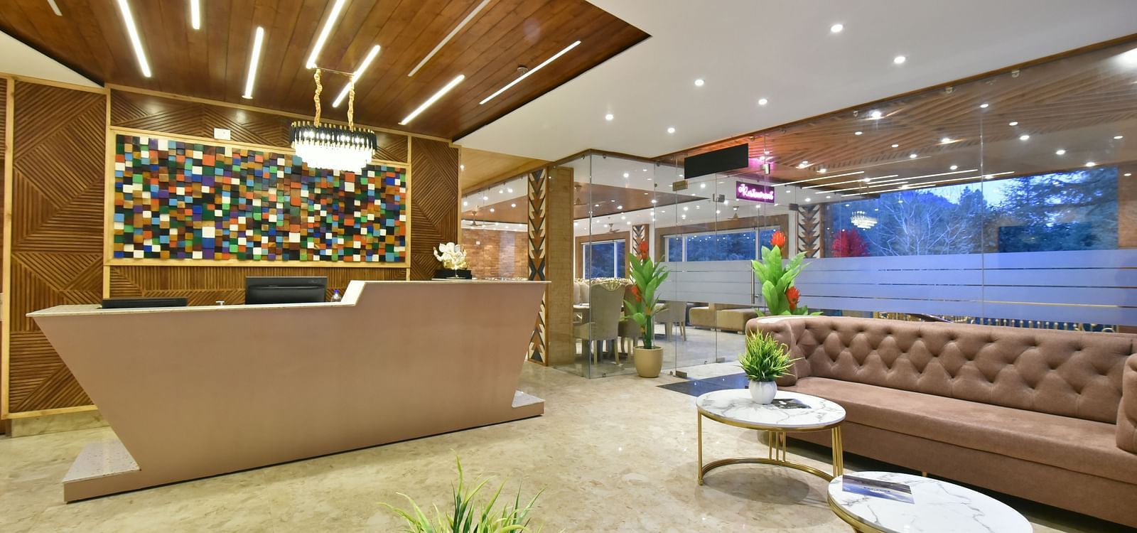 A reception desk in front of sofa seating in the lobby at DLS Ark Holiday Inn, Banikhet.