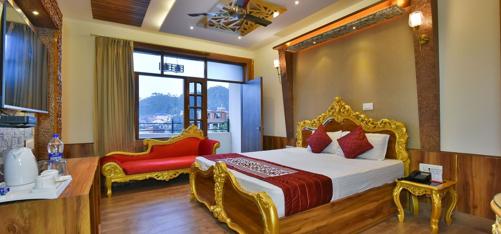 A Luxury Room at DLS Dalhousie Valley Resort with a premium bed, a sofa and balcony.