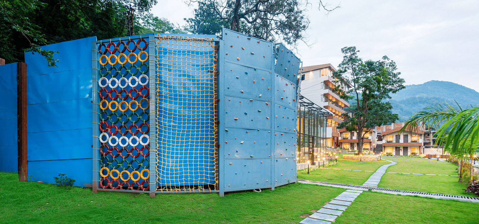 Adventure activities area in the garden of DLS Divine River Resort and Spa with rock climbing structure