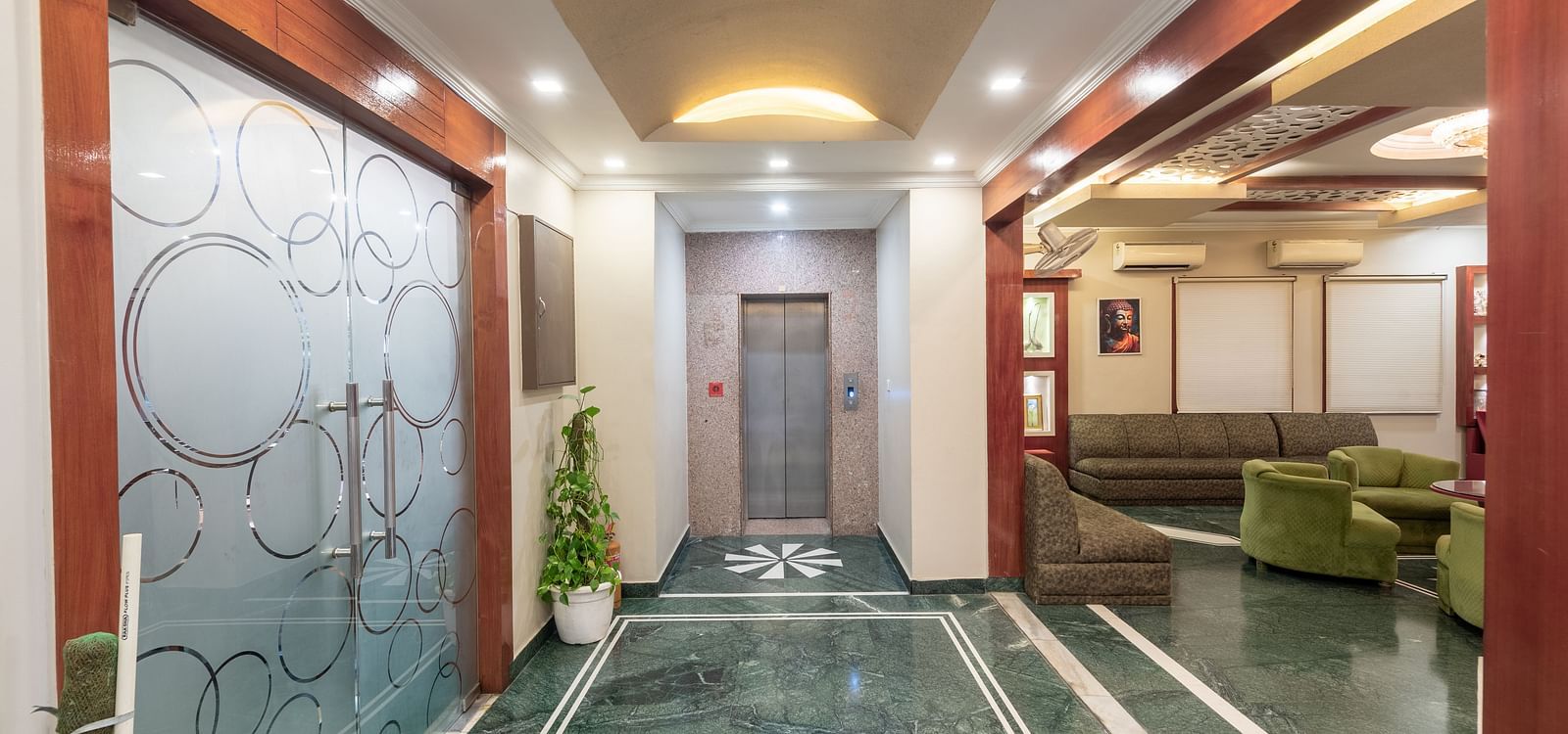 Elevator area at DLS Park Grace, Haridwar featuring the lift, seating area, and bright lighting.
