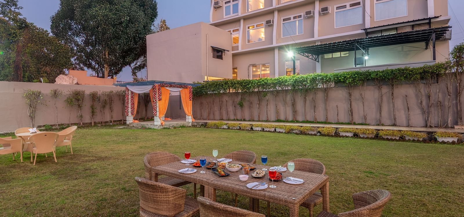 Lawn area at DLS Park Grace, Haridwar featuring multi storey building, seating area and beautiful green lawn.