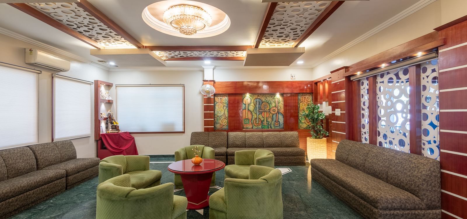Lobby area with cushion sofas and a fancy ceiling at DLS Park Grace, Haridwar.